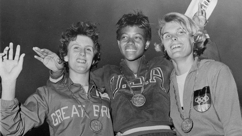 FILE - In this Sept. 5, 1960, file photo, the medalists in the women's 200-meter event, from left, bronze medalist Dorothy Hyman, of Great Britain; gold medalist Wilma Rudolph, of the United States, and silver medalist Jutta Heine, of Germany, pose w