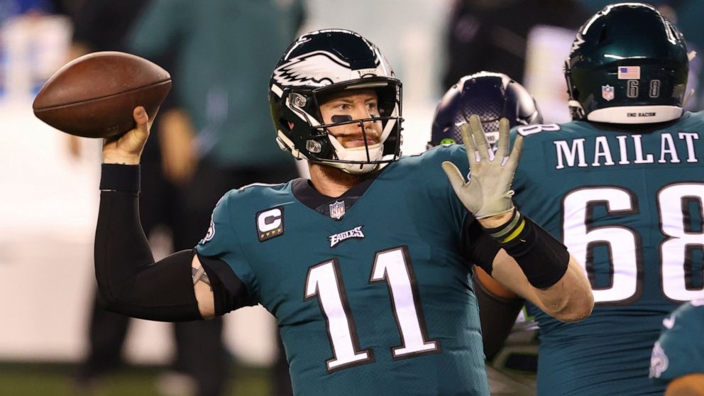 FILE - Philadelphia Eagles' Carson Wentz (11) passes during an NFL football game against the Seattle Seahawks in Philadelphia, in this Monday, Nov. 30, 2020, file photo. The Philadelphia Eagles have agreed to trade Carson Wentz to the Indianapolis Co