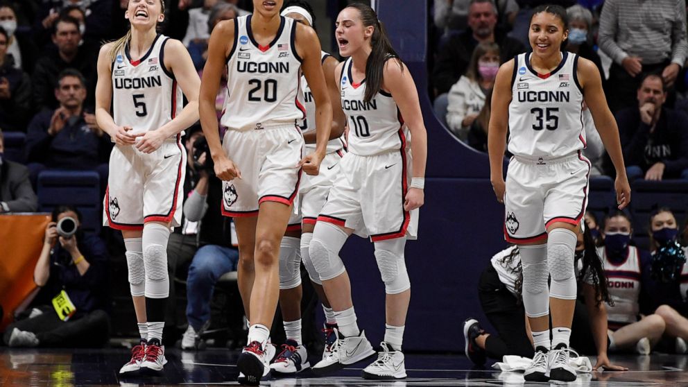 From left to right, Connecticut's Paige Bueckers, Olivia Nelson-Ododa, Nika Muhl and Azzi Fudd react during the first half of a second-round women's college basketball game against Central Florida in the NCAA tournament, Monday, March 21, 2022, in St