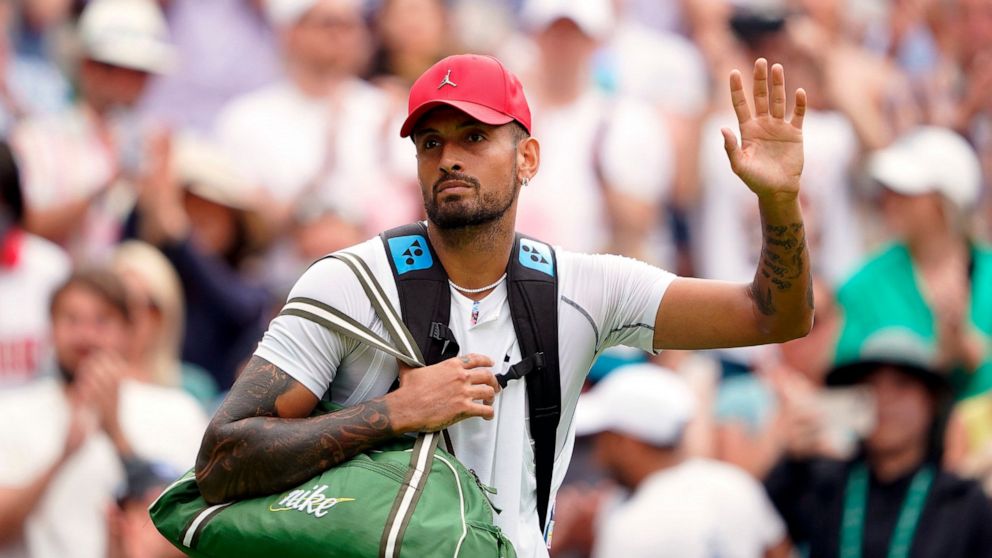 Australia's Nick Kyrgios waves as he walks off court after his fourth round men’s singles match against Brandon Nakashima of the United States on day eight of the Wimbledon tennis championships in London, Monday, July 4, 2022. After winning the match