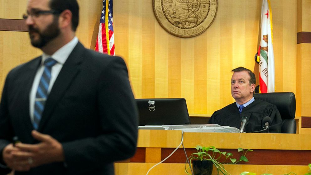 Judge Blaine Bowman, right, listens as Deputy District Attorney Dan Owens gives his opening statement to the jury on the opening day of former NFL football player Kellen Winslow Jr.'s rape trial, Monday, May 20, 2019, in Vista, Calif. (John Gibbins/T