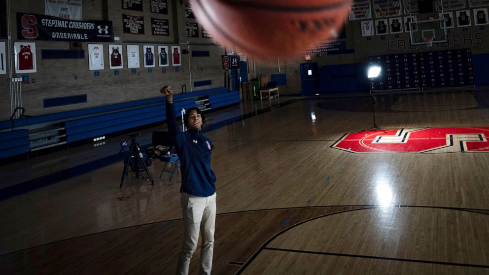 Johnuel "Boogie" Fland shoots hoops in the gymnasium of Archbishop Stepinac High School in White Plains, N.Y., Monday, May 2, 2022. Fland is among a growing number of high school athletes who have signed sponsorship deals for their name, image and li