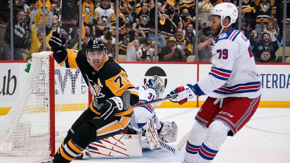 FILE - Pittsburgh Penguins' Evgeni Malkin (71) celebrates after his goal during the second period in Game 6 of an NHL hockey Stanley Cup first-round playoff series against the New York Rangers in Pittsburgh, May 13, 2022. Malkin has decided to go to 