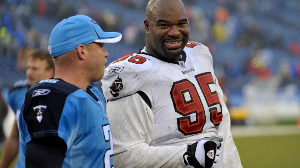 FILE - In this Sunday, Nov. 27, 2011 file photo, Tampa Bay Buccaneers defensive tackle Albert Haynesworth (95) talks with former teammate Tennessee Titans kicker Rob Bironas (2) after an NFL football game in Nashville, Tenn. Former Tennessee Titans A