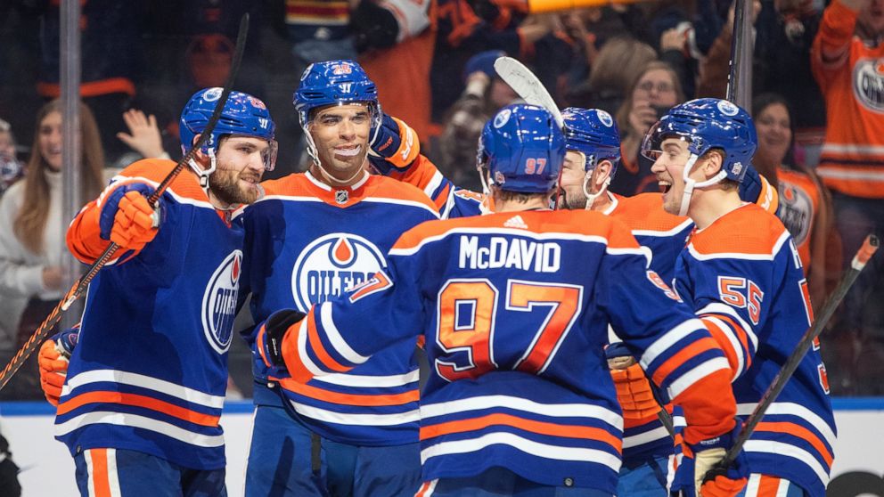 Edmonton Oilers' Leon Draisaitl (29), Darnell Nurse (25), Connor McDavid (97), Devin Shore (14) and Dylan Holloway (55) celebrate a goal against the Florida Panthers during overtime of an NHL hockey game in Edmonton, Alberta, Monday, Nov. 28, 2022. (