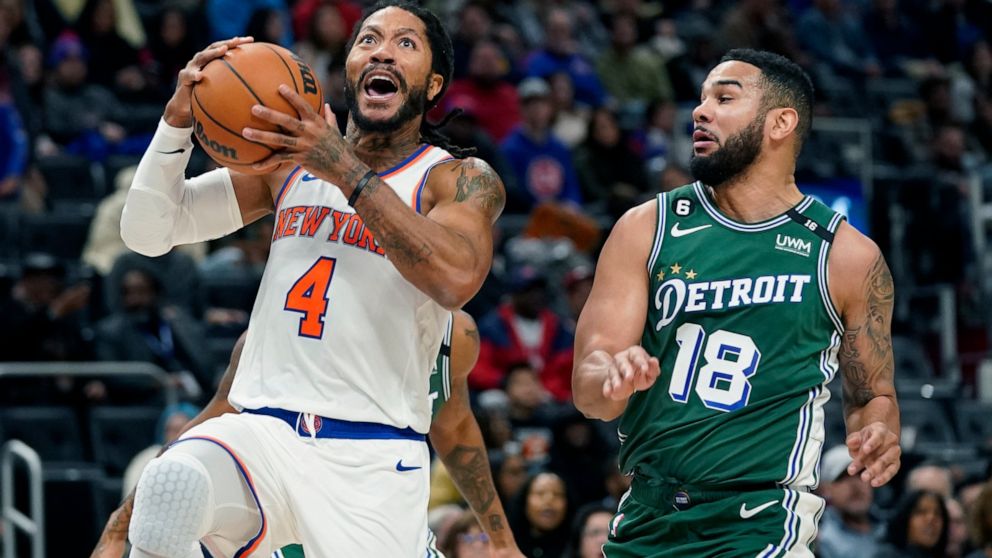 New York Knicks guard Derrick Rose (4) attempts a layup as Detroit Pistons guard Cory Joseph (18) defends during the second half of an NBA basketball game, Tuesday, Nov. 29, 2022, in Detroit. (AP Photo/Carlos Osorio)