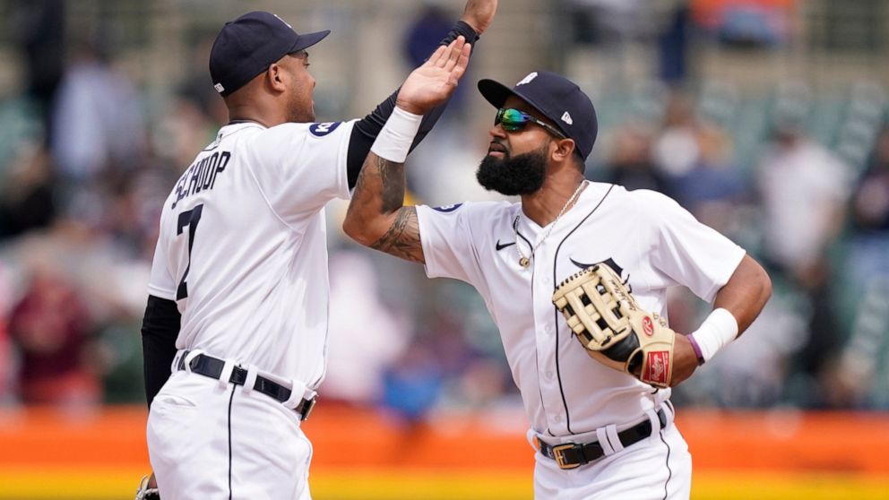 Detroit Tigers center fielder Derek Hill, right, greets second baseman Jonathan Schoop after the ninth inning in the first baseball game of a doubleheader against the Pittsburgh Pirates, Wednesday, May 4, 2022, in Detroit. (AP Photo/Carlos Osorio)