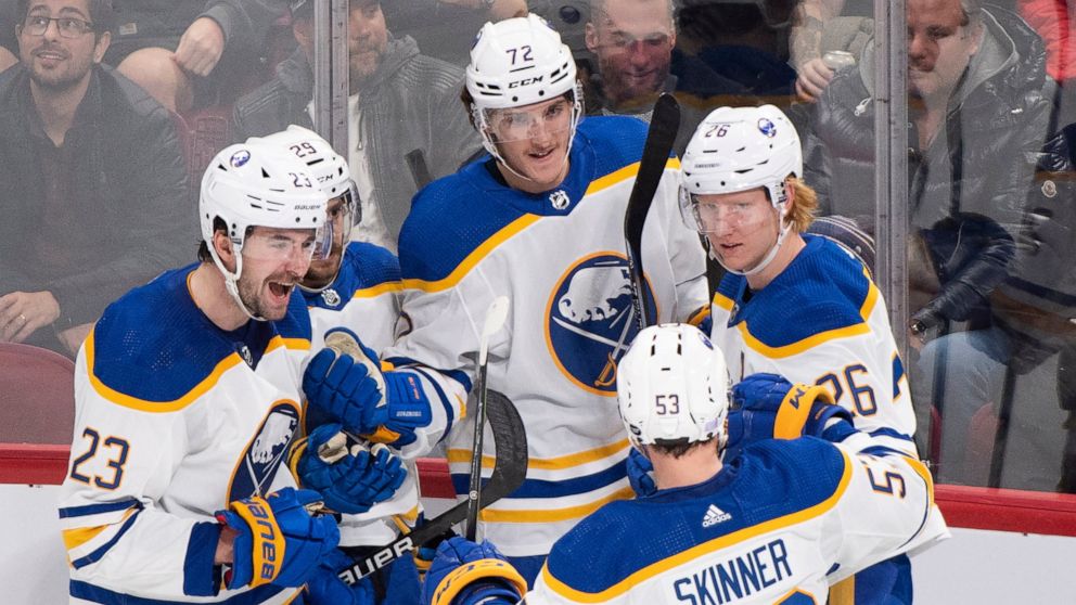 Buffalo Sabres' Tage Thompson (72) celebrates with teammates Mattias Samuelsson (23), Vinnie Hinostroza, Jeff Skinner (53) and Rasmus Dahlin (26) after scoring against the Montreal Canadiens during the third period of an NHL hockey game in Montreal, 