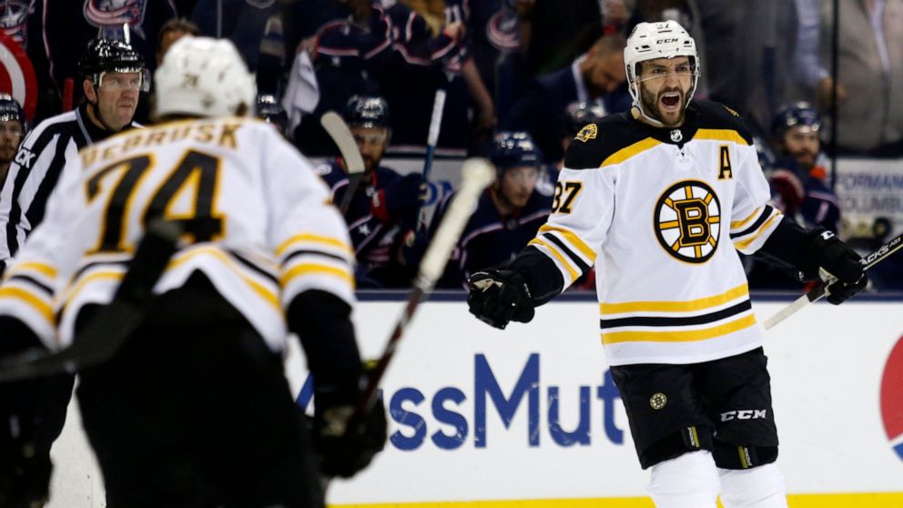 Boston Bruins forward Patrice Bergeron, right, celebrates his goal against the Columbus Blue Jackets with forward Jake DeBrusk during the first period of Game 4 of an NHL hockey second-round playoff series in Columbus, Ohio, Thursday, May 2, 2019. (A