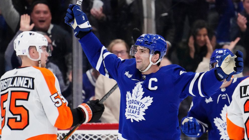 Toronto Maple Leafs' John Tavares (91) celebrates his third goal of the game against the Philadelphia Flyers during the third period of an NHL hockey game in Toronto on Wednesday, Nov. 2, 2022. (Frank Gunn/The Canadian Press via AP)