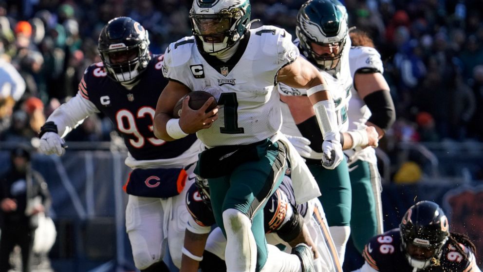 Philadelphia Eagles' Jalen Hurts runs for a touchdown during the first half of an NFL football game against the Chicago Bears, Sunday, Dec. 18, 2022, in Chicago. (AP Photo/Nam Y. Huh)