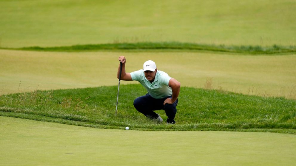 Brooks Koepka prepares to putt on the fourth hole during the third round of the U.S. Open golf tournament at The Country Club, Saturday, June 18, 2022, in Brookline, Mass. (AP Photo/Charles Krupa)