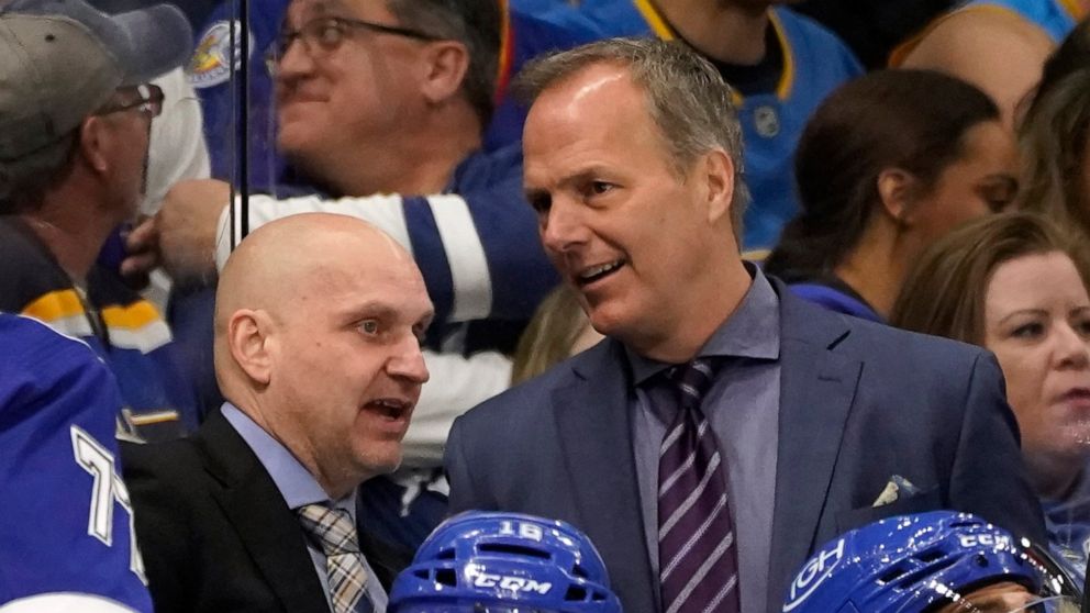 FILE -Tampa Bay Lightning coach Jon Cooper, right, and assistant coach Derek Lalonde talk during the third period of the team's NHL hockey game against the St. Louis Blues on Dec. 2, 2021, in Tampa, Fla. The Detroit Red Wings have hired Lalonde as th