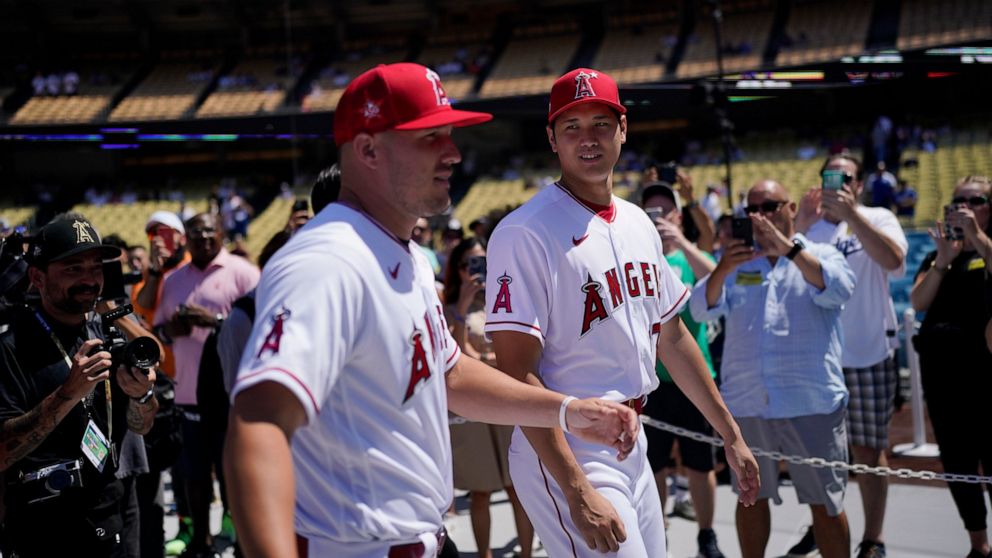 Los Angeles Angels' Mike Trout, left, and Shohei Ohtani enter the field during batting practice a day before the 2022 MLB All-Star baseball game, Monday, July 18, 2022, in Los Angeles. (AP Photo/Jae C. Hong)