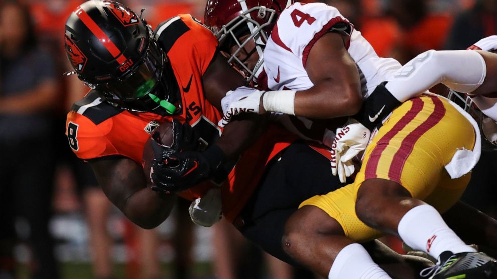 Oregon State running back Jam Griffin is brought down by Southern California defensive back Max Williams during the first half of an NCAA college football game Saturday, Sept. 24, 2022, in Corvallis, Ore. (AP Photo/Amanda Loman)