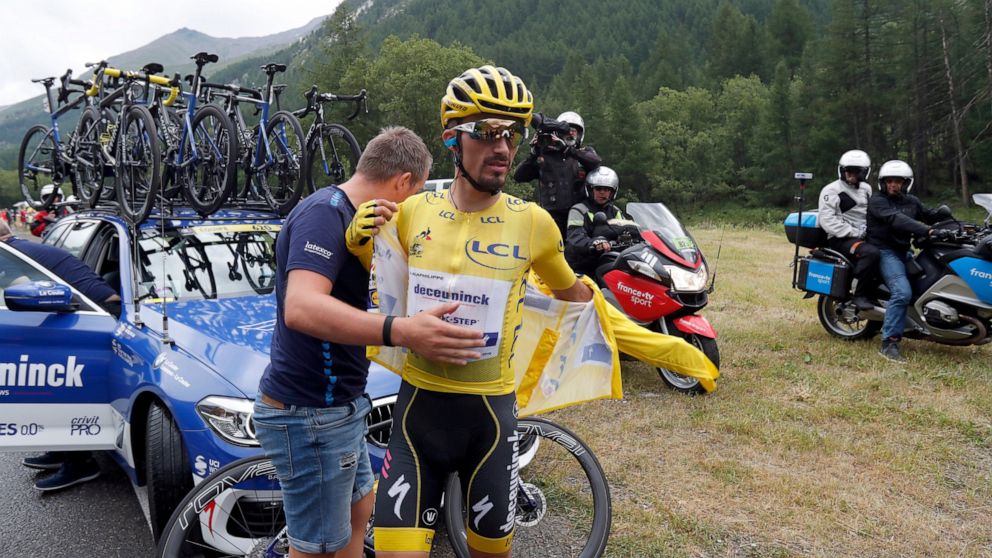 France's Julian Alaphilippe wearing the overall leader's yellow jersey puts on a jacket during the nineteenth stage of the Tour de France cycling race over 126,5 kilometers (78,60 miles) with start in Saint Jean De Maurienne and finish in Tignes, Fra