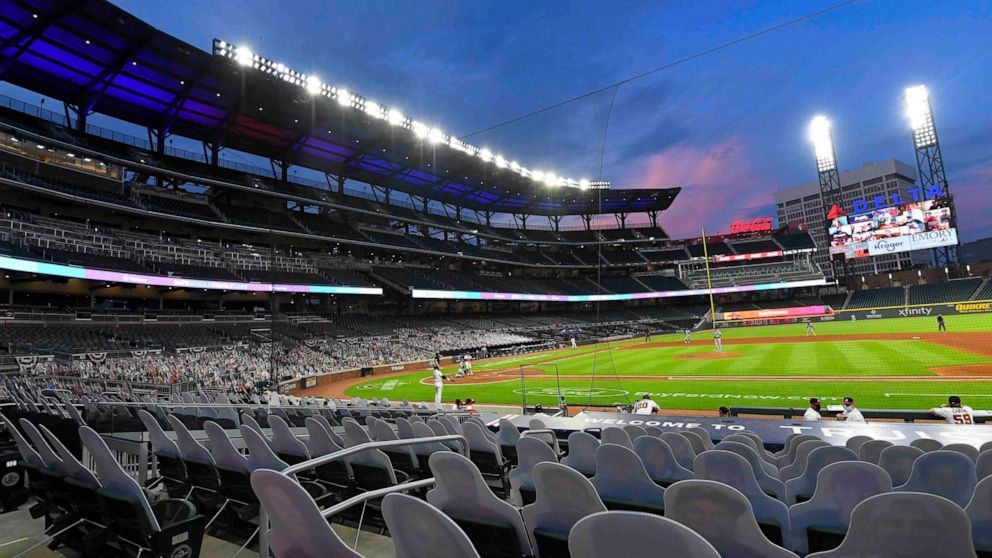 FILE - This photo from Thursday July 30, 2020, shows cardboard cutouts of fans in seats during a baseball game between the Atlanta Braves and Tampa Bay Rays at Truist Park stadium in Atlanta, Georgia. A Manhattan judge has rejected an attempt to forc