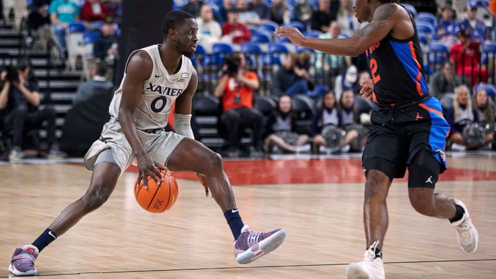 Xavier guard Souley Boum, left, is defended by Florida guard Trey Bonham during the first half of an NCAA college basketball game in the Phil Knight Legacy tournament in Portland, Ore., Thursday, Nov. 24, 2022. (AP Photo/Craig Mitchelldyer)