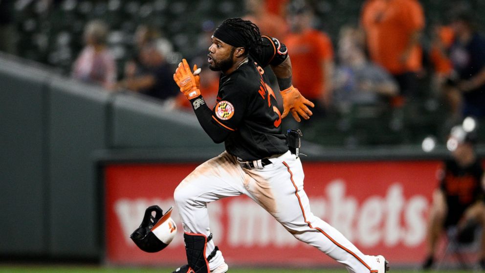 Baltimore Orioles' Cedric Mullins runs toward second base after he singled during the fourth inning of a baseball game against the Boston Red Sox, Friday, Sept. 9, 2022, in Baltimore. Mullins was tagged out on the play. (AP Photo/Nick Wass)
