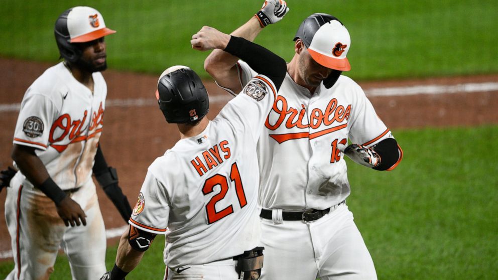 Baltimore Orioles' Trey Mancini, right, celebrates his two-run home run with Austin Hays (21) and Cedric Mullins, left, during the sixth inning of the team's baseball game against the Seattle Mariners, Wednesday, June 1, 2022, in Baltimore. (AP Photo