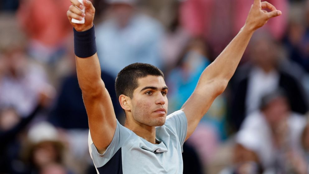 Spain's Carlos Alcaraz celebrates winning against Spain's Albert Ramos-Vinolas in five sets, 6-1, 6-7 (9-7), 5-7, 7-6 (7-2), 6-4, during their second round match at the French Open tennis tournament in Roland Garros stadium in Paris, France, Wednesda