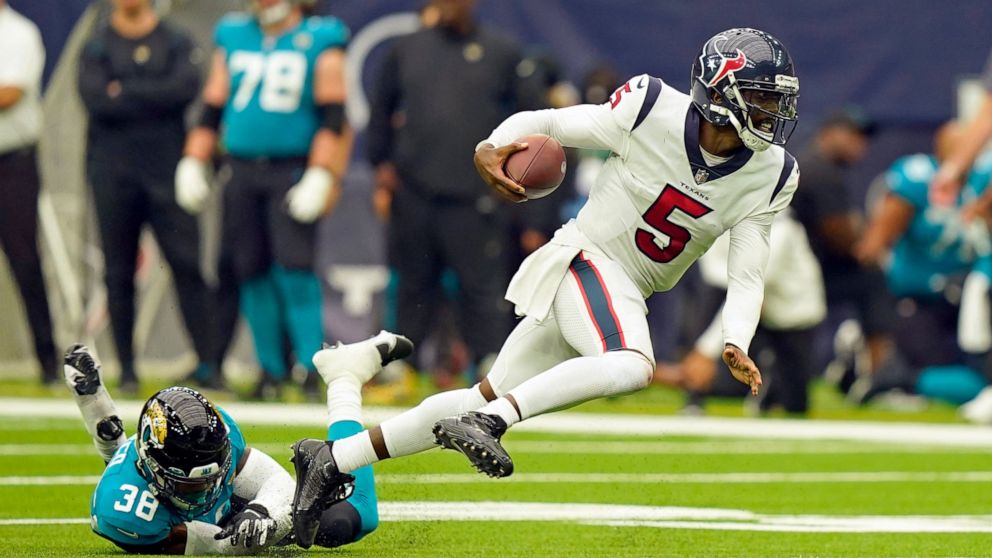 Houston Texans quarterback Tyrod Taylor (5) breaks away from Jacksonville Jaguars safety Andre Cisco (38) during the second half of an NFL football game Sunday, Sept. 12, 2021, in Houston. (AP Photo/Eric Christian Smith)