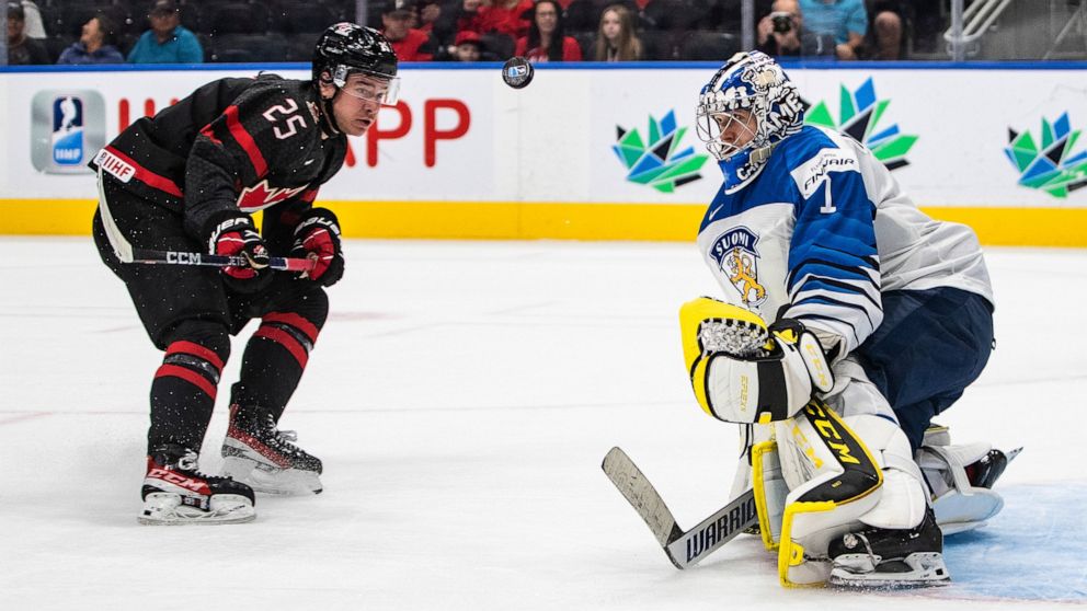 Canada's William Dufour (25) is stopped by Finland goalie Leevi Merilainen (1) during the second period of an IIHF world junior hockey championships game Monday, Aug. 15, 2022, in Edmonton, Alberta. (Jason Franson/The Canadian Press via AP)