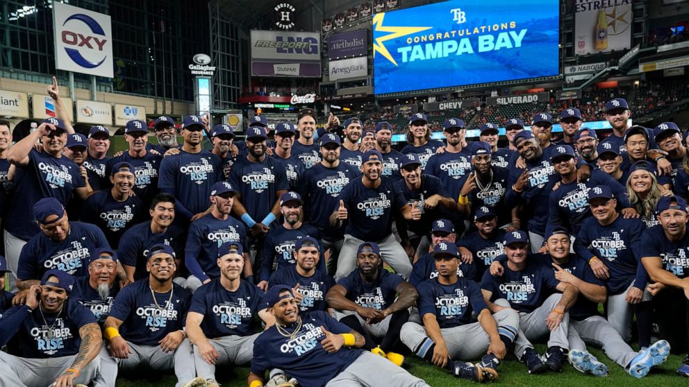 The Tampa Bay Rays pose for a team picture after a baseball game against the Houston Astros Friday, Sept. 30, 2022, in Houston. The Rays won 7-3 and clinched a postseason berth. (AP Photo/David J. Phillip)