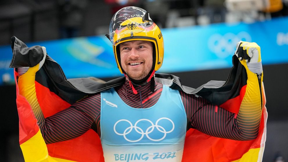 FILE - Johannes Ludwig, of Germany, celebrates winning the gold medal in luge men's single at the 2022 Winter Olympics, on Feb. 6, 2022, in the Yanqing district of Beijing. Ludwig announced his retirement Monday, May 16, 2022, on social media. (AP Ph