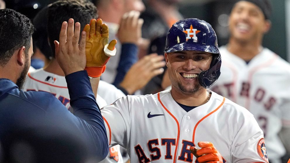 Houston Astros' Aledmys Diaz celebrates with teammates in the dugout after hitting a two-run home run against the Oakland Athletics during the seventh inning of a baseball game Thursday, Sept. 15, 2022, in Houston. (AP Photo/David J. Phillip)