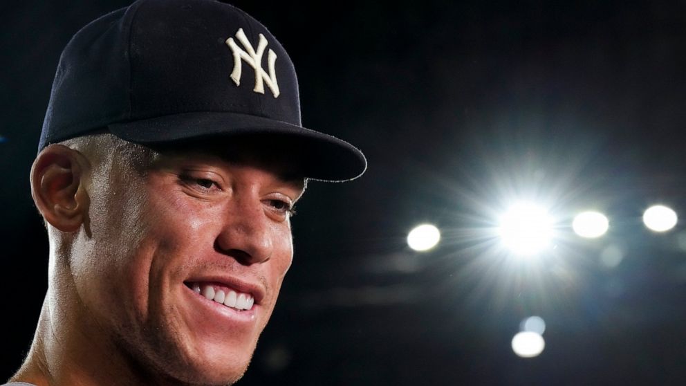 FILE -New York Yankees' Aaron Judge smiles as he speaks during an interview after the team's baseball game against the Toronto Blue Jays, in which he hit his 61st home run of the season, Wednesday, Sept. 28, 2022, in Toronto. After hitting 62 home ru