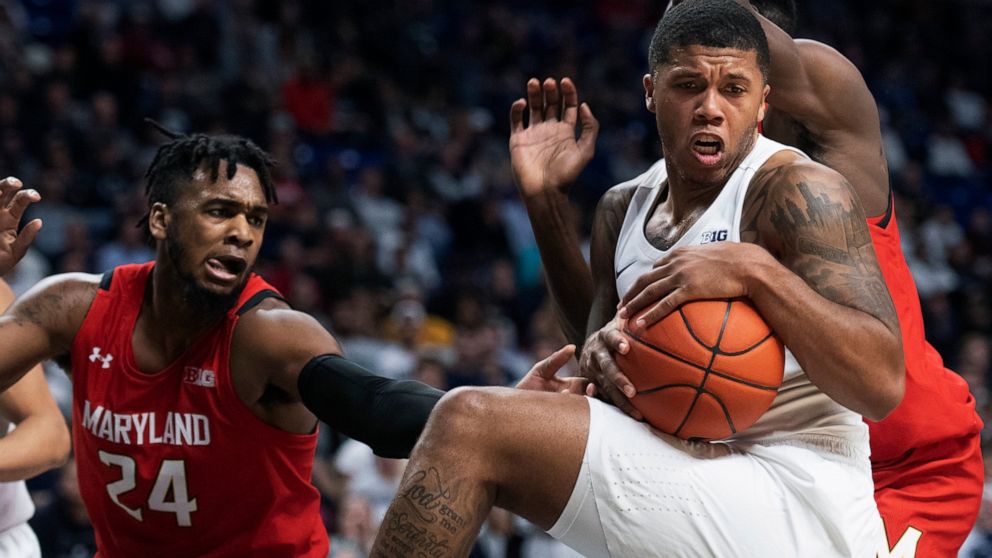 Penn State guard Myles Dread, right, beats Maryland forward Donta Scott (24) to a rebound in the first half of an NCAA college basketball game in State College, Pa., on Tuesday, Dec. 10, 2019. (AP Photo/Barry Reeger)