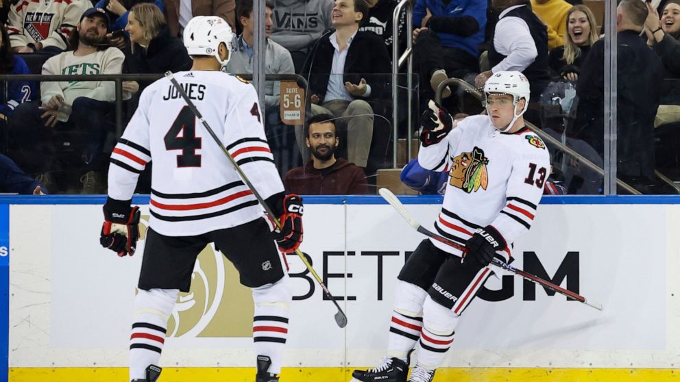 Chicago Blackhawks center Max Domi (13) celebrates with defenseman Seth Jones (4) after scoring a goal against the New York Rangers during the second period of an NHL hockey game, Saturday, Dec. 3, 2022, in New York. (AP Photo/Jessie Alcheh)
