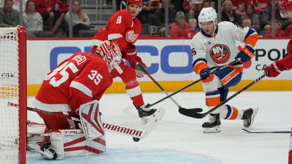 Detroit Red Wings goaltender Ville Husso (35) stops a New York Islanders right wing Oliver Wahlstrom (26) shot in the first period of an NHL hockey game Saturday, Nov. 5, 2022, in Detroit. (AP Photo/Paul Sancya)