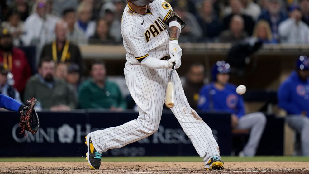 San Diego Padres' Manny Machado hits an RBI-double during the sixth inning of a baseball game against the Chicago Cubs, Tuesday, May 10, 2022, in San Diego. (AP Photo/Gregory Bull)