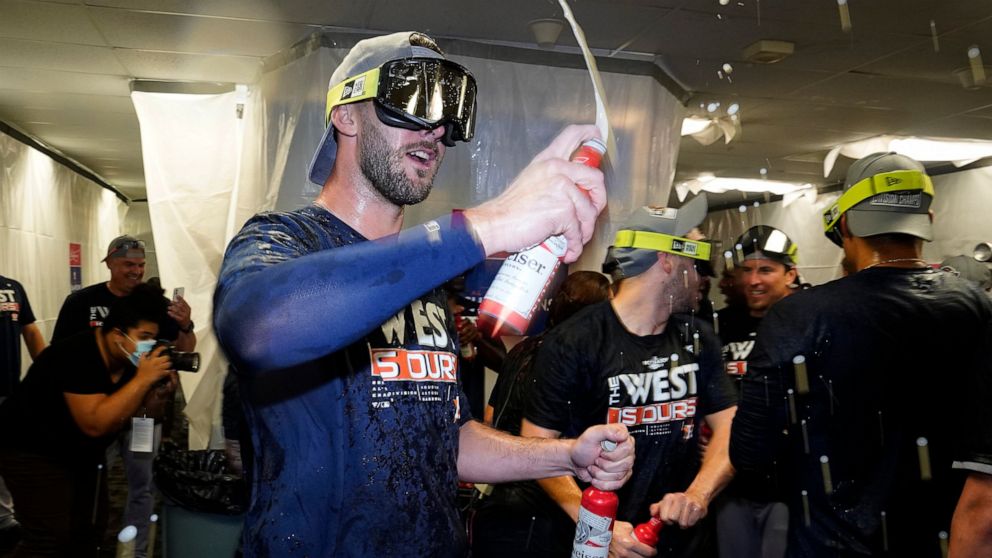 Houston Astros players celebrate in the clubhouse after clinching the American League West title with a win over the Tampa Bay Rays during a baseball game Monday, Sept. 19, 2022, in St. Petersburg, Fla. (AP Photo/Chris O'Meara)
