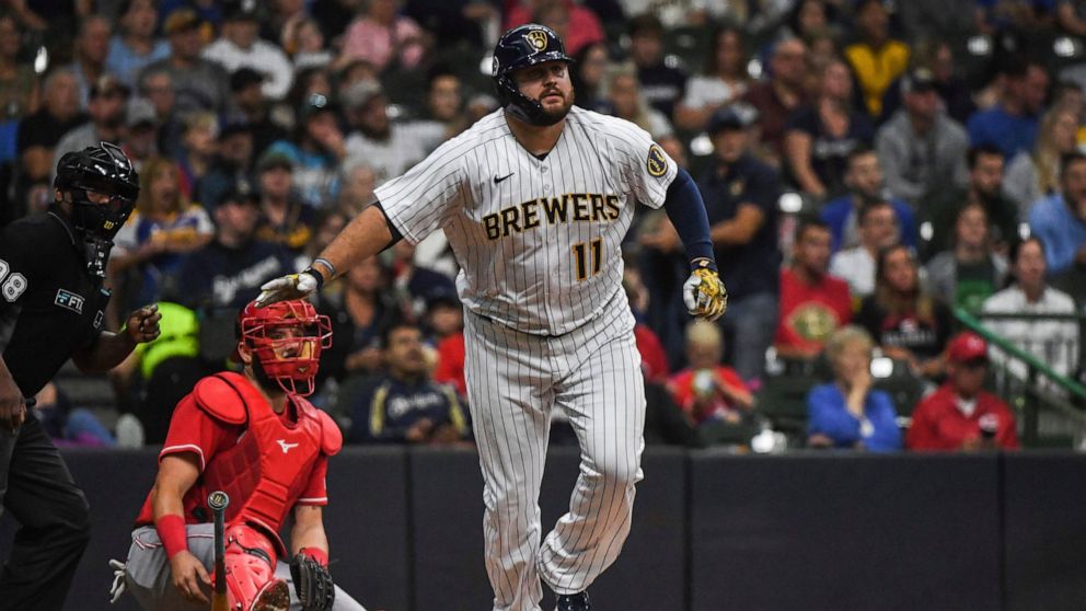 Milwaukee Brewers' Rowdy Tellez, right, watches his home run during the second inning of a baseball game against the Cincinnati Reds, Sunday, Sept. 11, 2022, in Milwaukee. (AP Photo/Kenny Yoo)