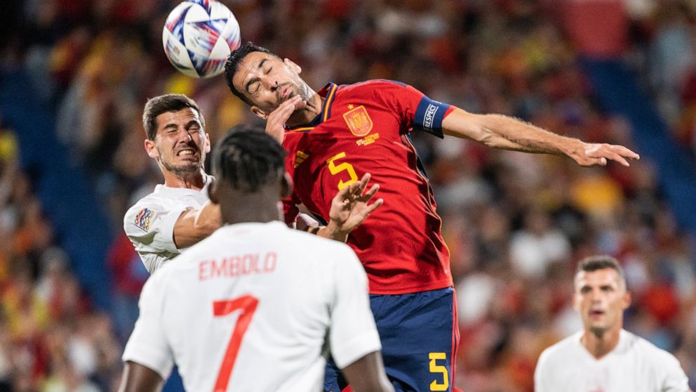 FILE - Swiss Remo Freuler, left, fights for a header with Spain's midfielder Sergio Busquets, during the UEFA Nations League group A2 soccer match between Spain and Switzerland at the Romareda stadium in Zaragoza, Spain, Saturday, Sept. 24, 2022. (Je