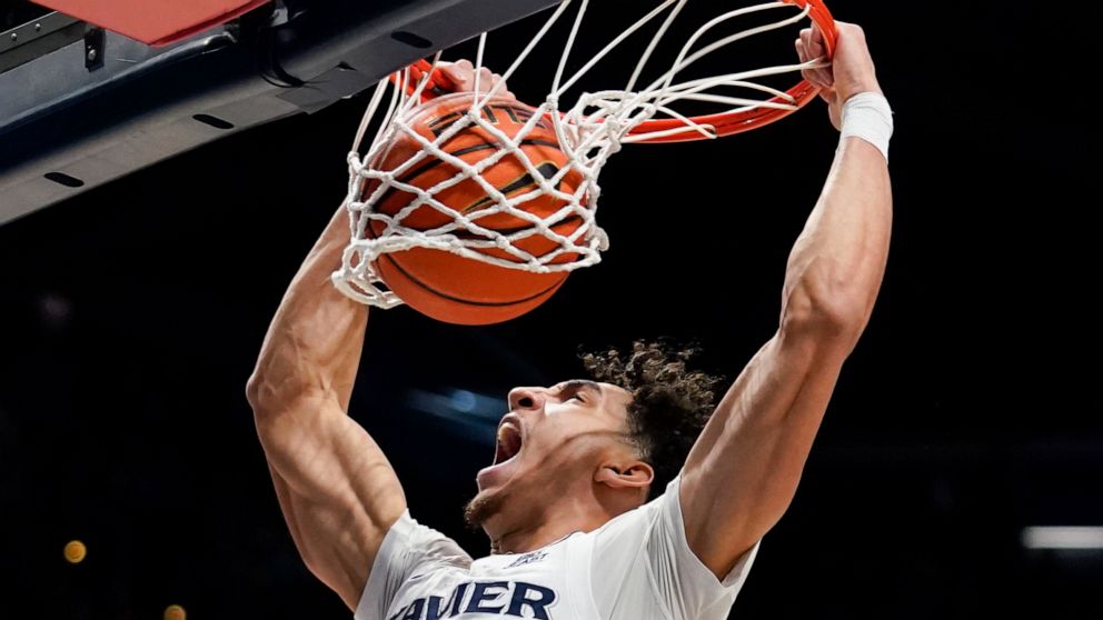 Xavier guard Colby Jones dunks during the first half of the team's NCAA college basketball game against Connecticut, Friday, Feb. 11, 2022, in Cincinnati. (AP Photo/Jeff Dean)