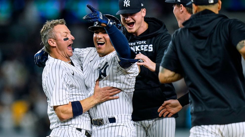 New York Yankees' Jose Trevino, second from left, celebrates with teammates after hitting a single to drive in the winning run during the 13th inning of the team's baseball game against the Chicago Cubs on Friday, June 10, 2022, in New York. The Yank
