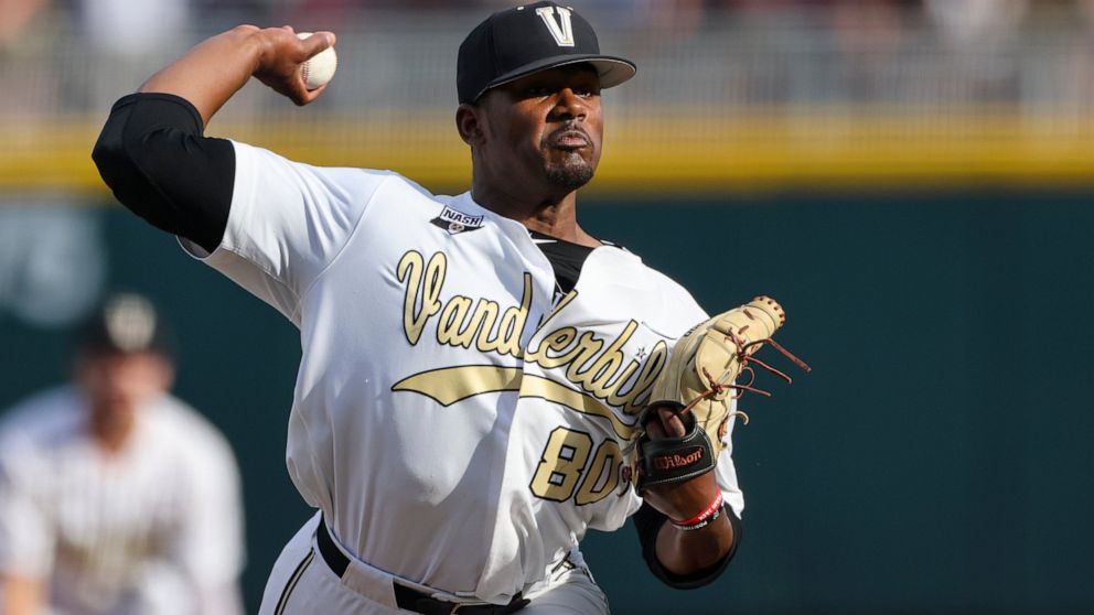 FILE - Vanderbilt pitcher Kumar Rocker (80) throws during the first inning in Game 3 of the NCAA College World Series baseball finals on June 30, 2021, in Omaha, Neb. Third overall pick Kumar Rocker signed with the Texas Rangers on Tuesday, July 26, 
