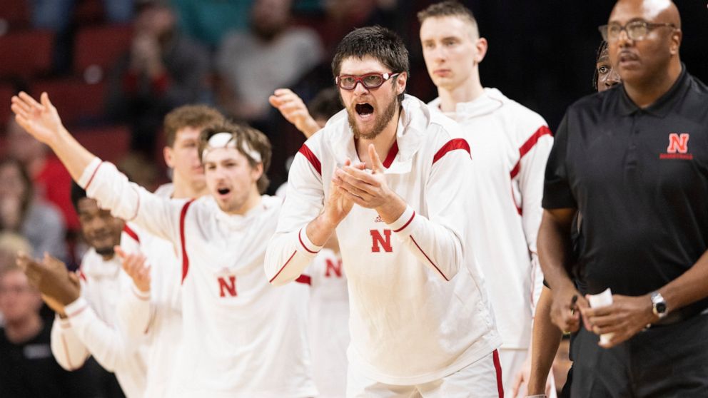 Alongside teammates on the bench, Nebraska's Wilhelm Breidenbach, second from front right, celebrates after a 3-point basket against Arkansas-Pine Bluff during the second half of an NCAA college basketball game on Sunday, Nov. 20, 2022, in Lincoln, N