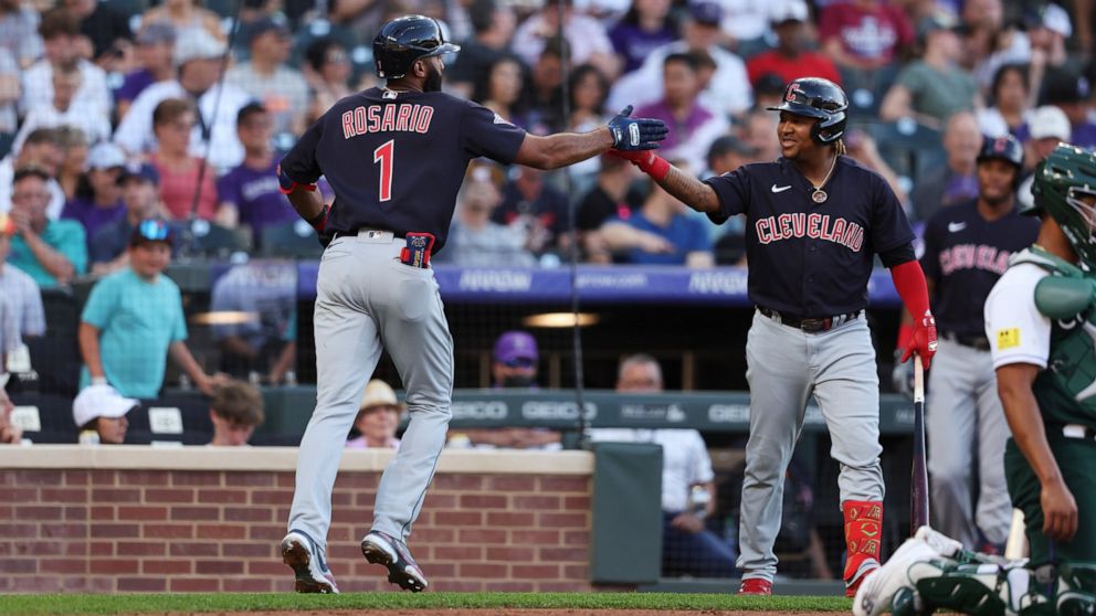 Cleveland Guardians' Amed Rosario, left, celebrates with Jose Ramirez after hitting a home run against the Colorado Rockies during the third inning of a baseball game Wednesday, June 15, 2022, in Denver. (AP Photo/Gabriel Christus)