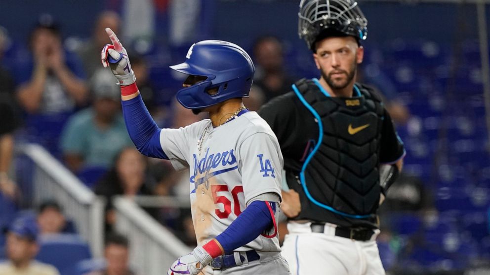 Los Angeles Dodgers' Mookie Betts (50) gestures after hitting a two-run home run in the seventh inning of a baseball game against the Miami Marlins, Friday, Aug. 26, 2022, in Miami. (AP Photo/Marta Lavandier)