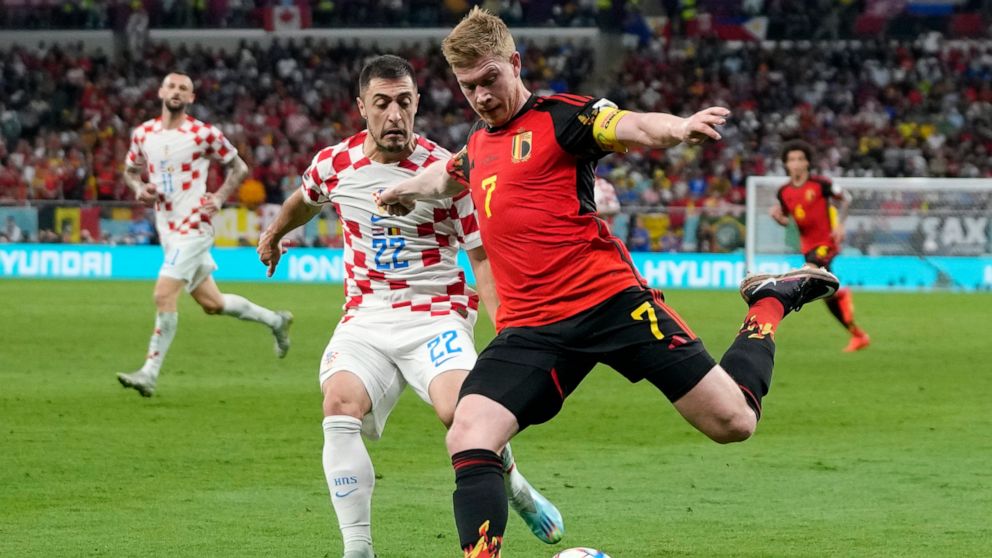 Belgium's Kevin De Bruyne, right, and Croatia's Josip Juranovic, left, fight for the ball during the World Cup group F soccer match between Croatia and Belgium at the Ahmad Bin Ali Stadium in Al Rayyan , Qatar, Thursday, Dec. 1, 2022. (AP Photo/Thana
