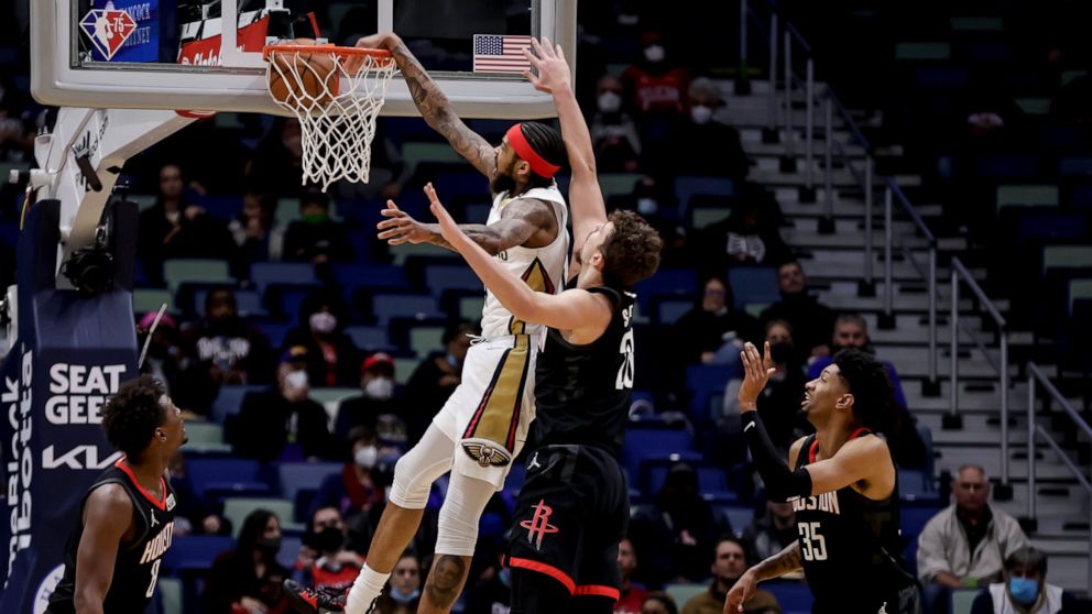 New Orleans Pelicans forward Brandon Ingram (14) dunks over Houston Rockets center Alperen Sengun (28) during the first quarter of an NBA basketball game in New Orleans, Tuesday, Feb. 8, 2022. (AP Photo/Derick Hingle)