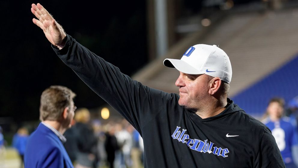 Duke head coach Mike Elko waves to fans as he walks off the field after earning a victory in Duke's final regular season NCAA college football game against Wake Forest in Durham, N.C., Saturday, Nov. 26, 2022. (AP Photo/Ben McKeown)