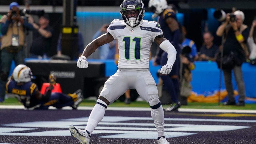 Seattle Seahawks wide receiver Marquise Goodwin (11) celebrates after scoring a touchdown during the first half of an NFL football game against the Los Angeles Chargers Sunday, Oct. 23, 2022, in Inglewood, Calif. (AP Photo/Mark J. Terrill)