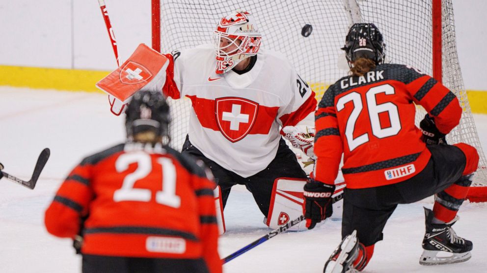 Emily Clark of Canada scores to 3-0 in action with goalkeeper Andrea Braendli of Switzerland during the IIHF World Championship Woman's ice hockey match between Canada and Switzerland in Herning, Denmark, Saturday, Aug. 27, 2022. (Bo Amstrup/Ritzau S