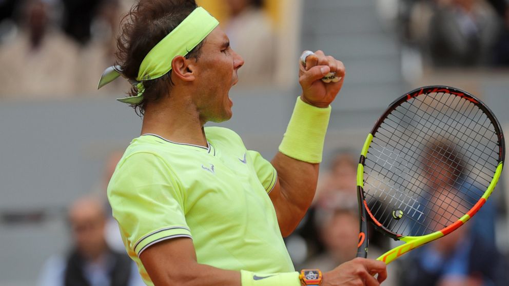 Spain's Rafael Nadal clenches his fist after scoring a point against Switzerland's Roger Federer during their semifinal match of the French Open tennis tournament at the Roland Garros stadium in Paris, Friday, June 7, 2019. (AP Photo/Michel Euler)